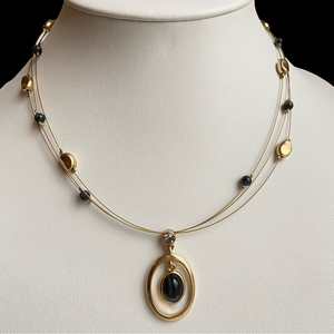 Lia Sophia Matinee goldtone triple wire pendant necklace with black cat’s eye